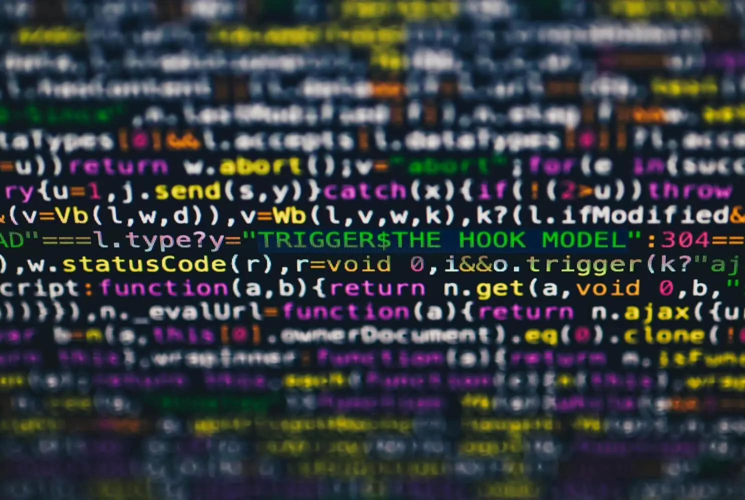 Close-up of blurred, colourful computer code on a screen