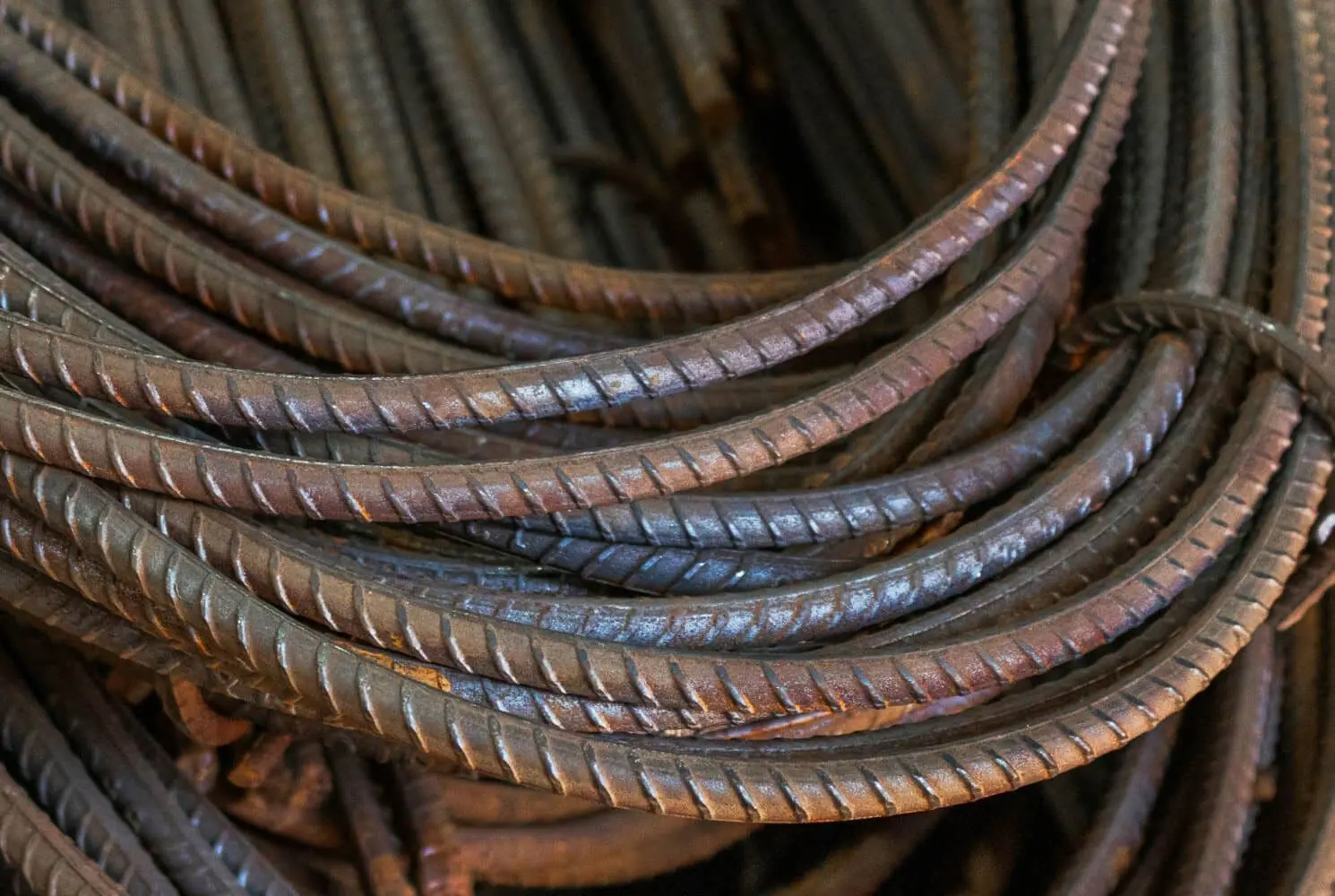 Close-up of coiled steel reinforcement bars with ribbed surfaces